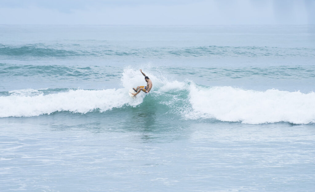 a man surfing in playa carmen, costa rica